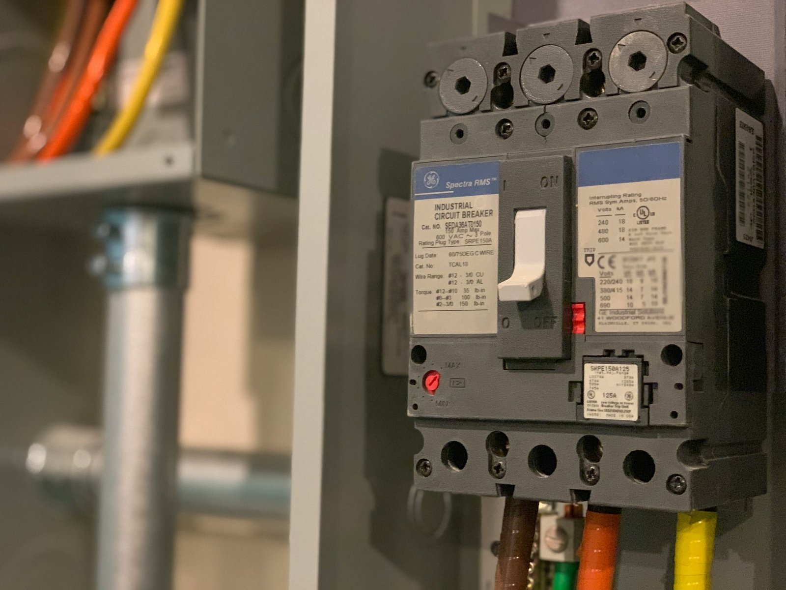 Comparison of 100-amp and 200-amp electrical panels showing breaker capacity