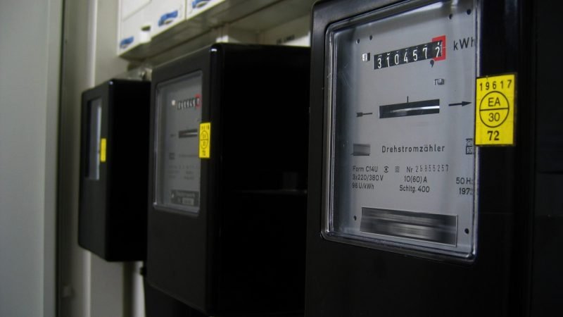 Close-up showing an electrical panel busbar rating label and solar breaker position used in NEC 705 calculations.