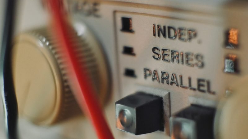 Close-up showing an electrical panel busbar rating label and solar breaker position used in NEC 705 calculations.